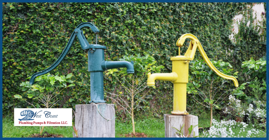 Two well pumps in a residential yard.